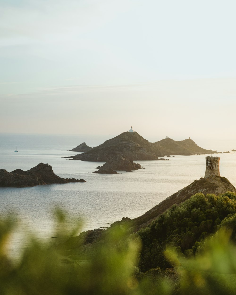 a lighthouse on a small island in the middle of the ocean