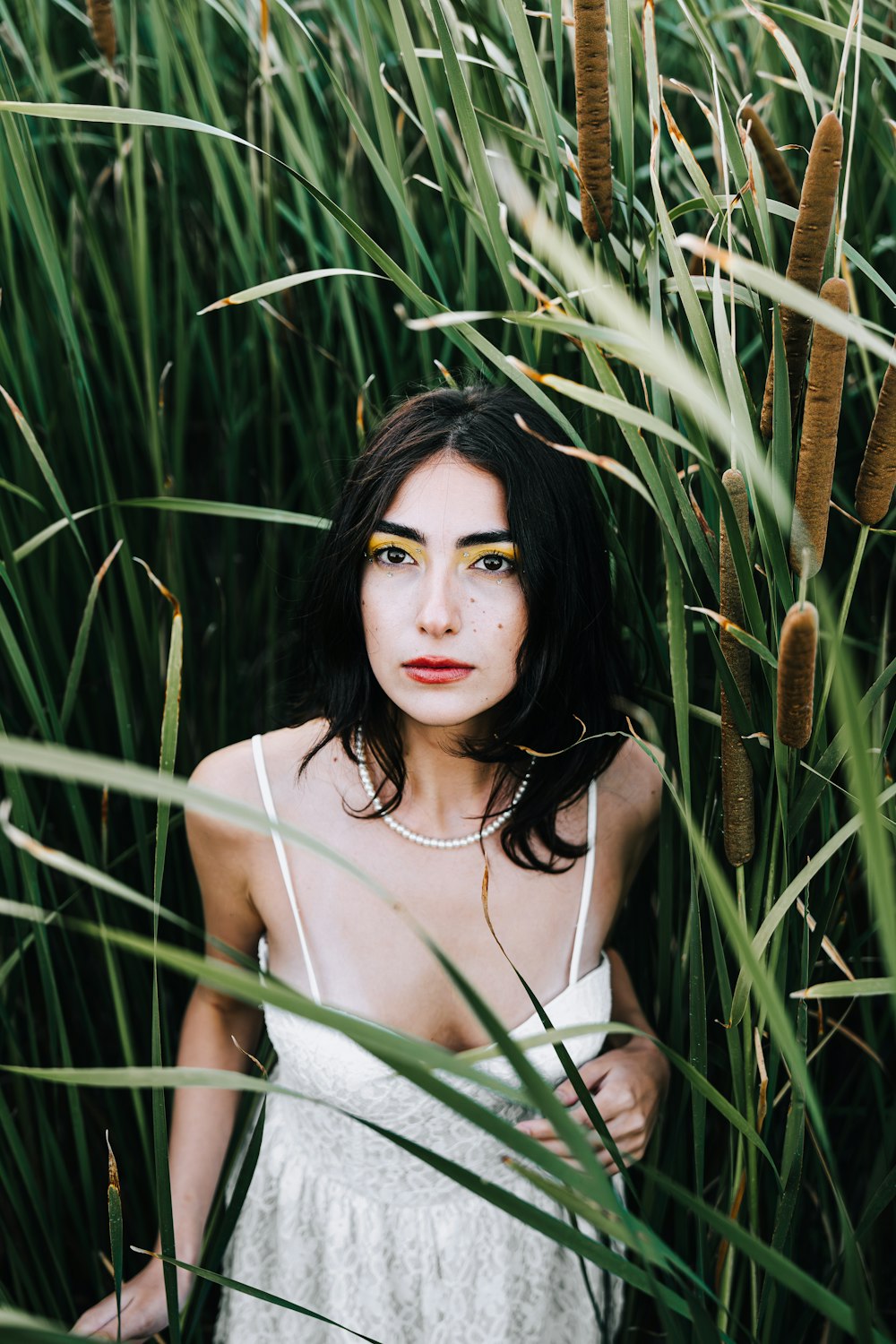 a woman standing in a field of tall grass