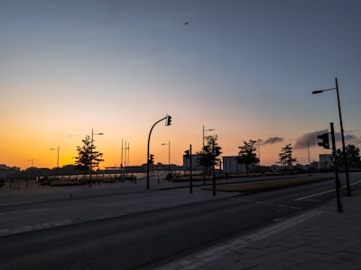 A serene street scene at dusk, featuring soft lighting and empty benches, evoking a sense of calm in an urban environment.