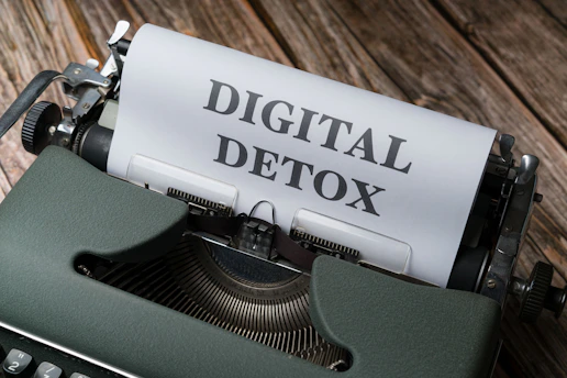 a close up of a typewriter with a paper that reads digital detox