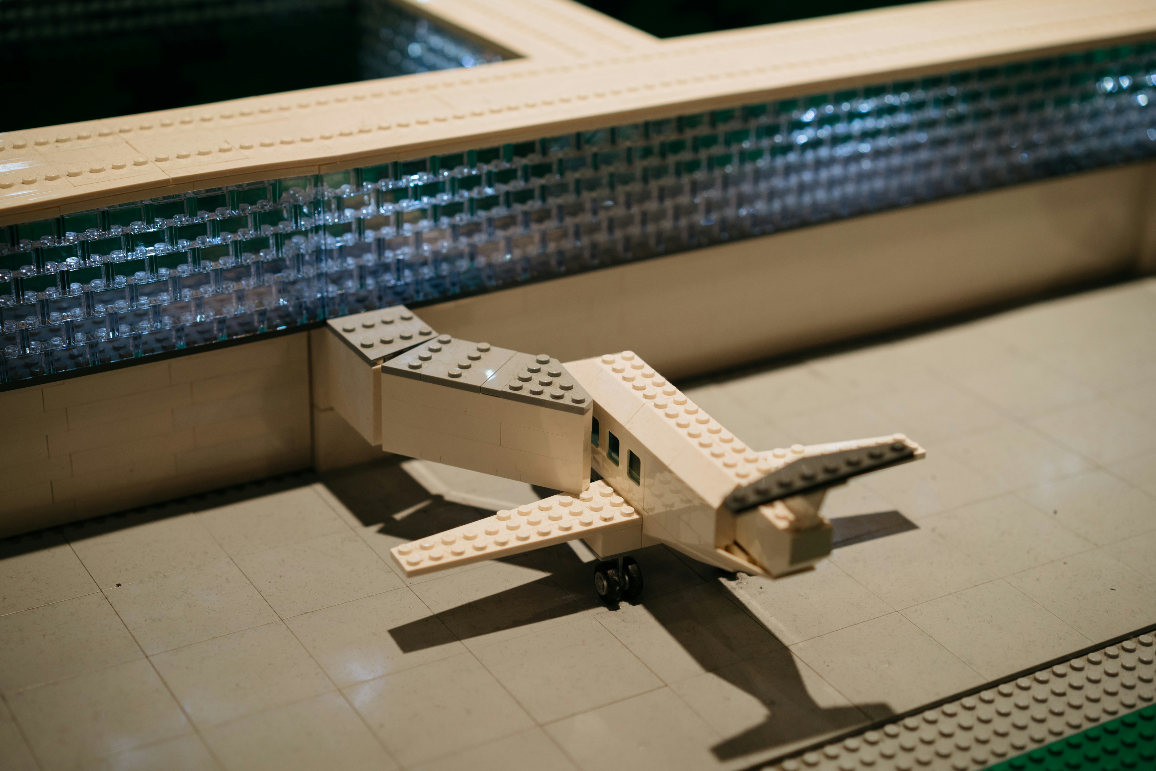 a toy airplane sitting on a tiled floor