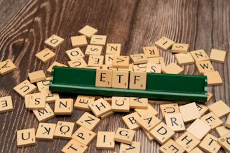 scrabble tiles spelling out letters on a wooden table