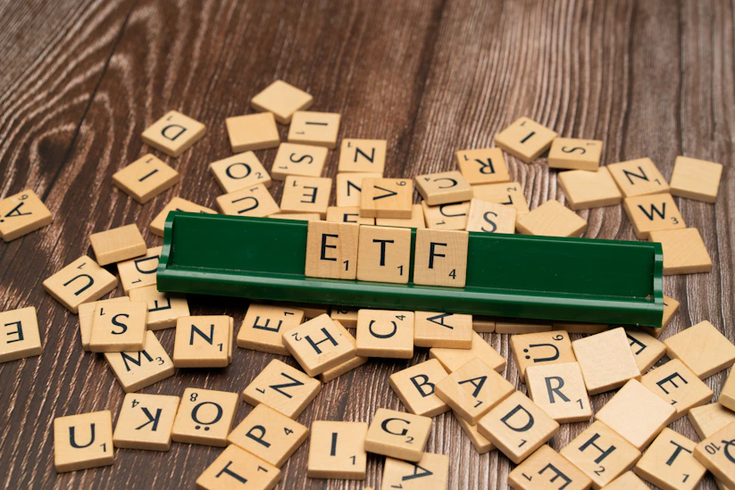 scrabble tiles spelling out letters on a wooden table