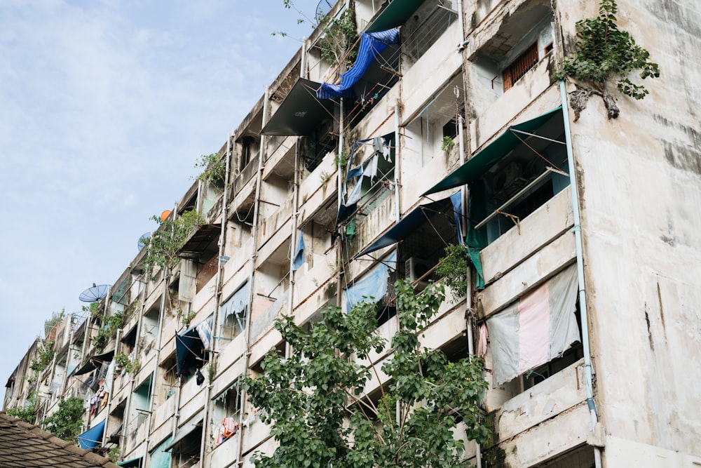 a tall building with lots of balconies and plants on the balconies