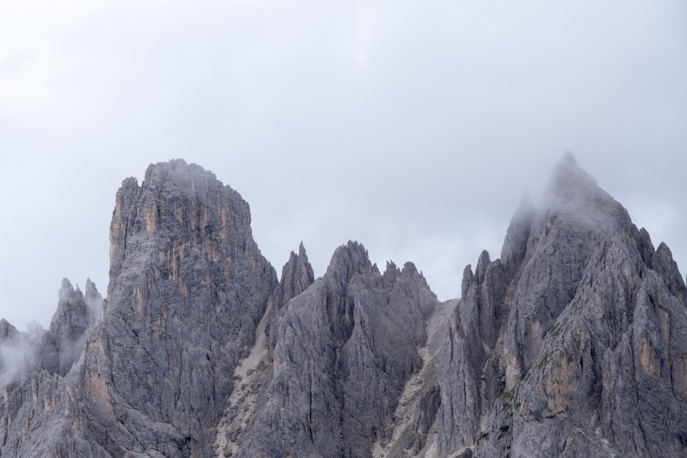 a very tall mountain covered in fog and clouds