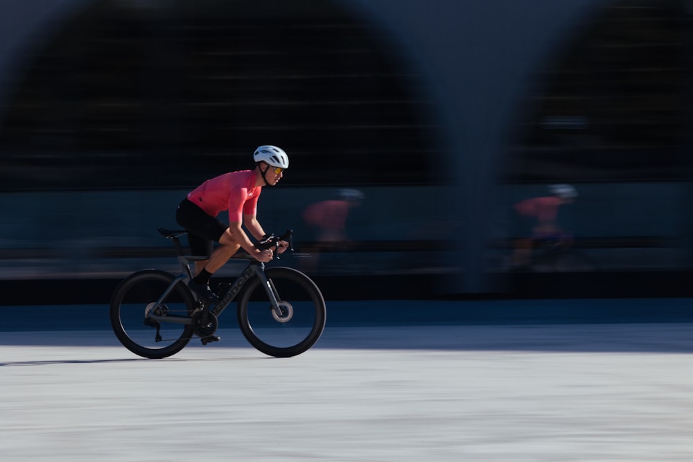 a man riding a bike down a street