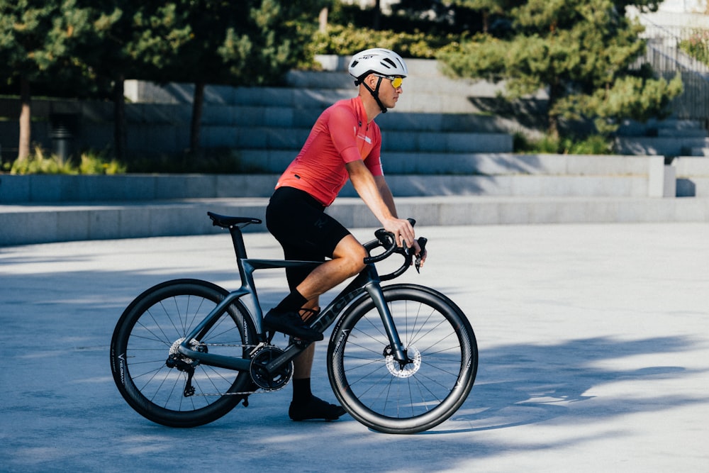 a man riding a bike in a parking lot