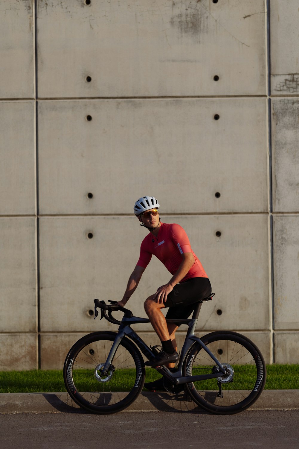 a man riding a bike down a street