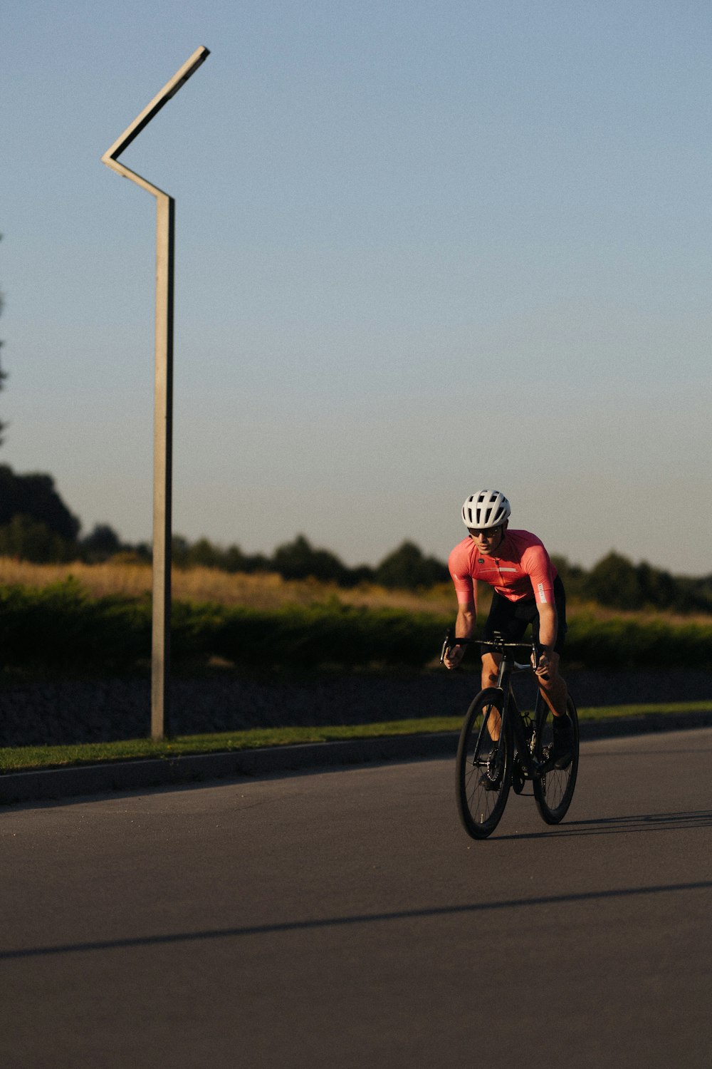 a man riding a bike down a street