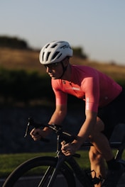 Cyclist riding on a mountain trail during sunrise, showcasing endurance and focus.