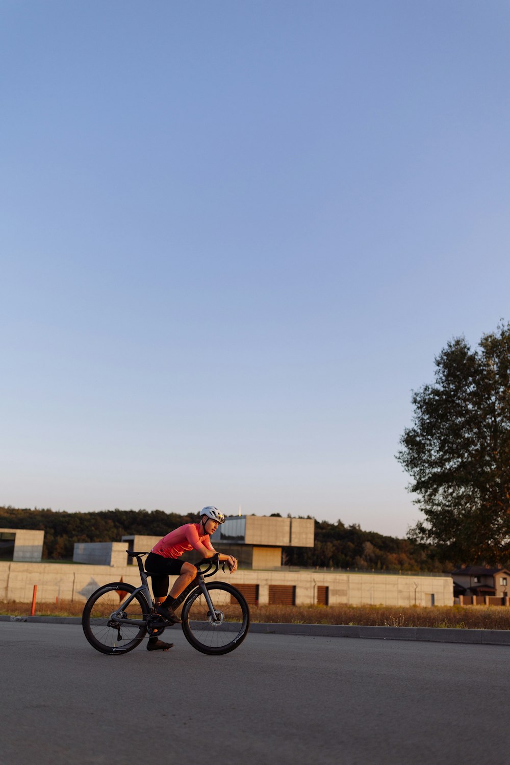 a man riding a bike down the middle of a street