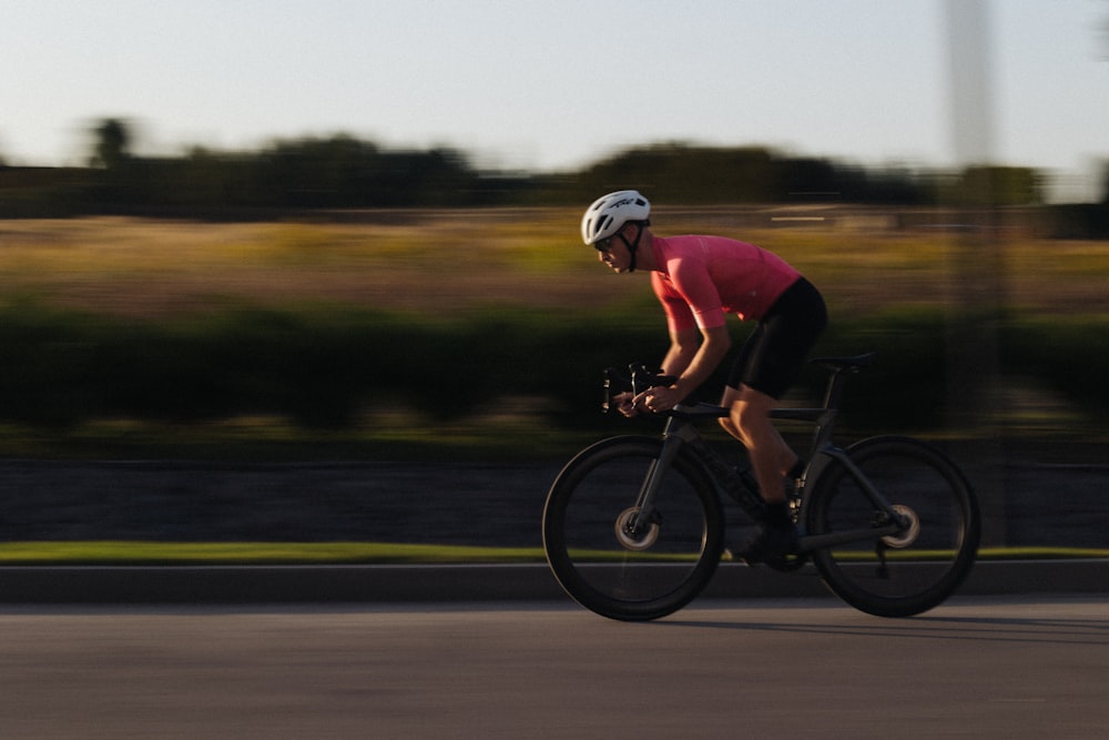 a man riding a bike down a street