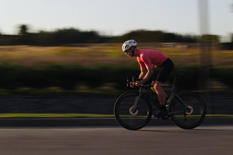 A cyclist sharp against a streaked background from panning