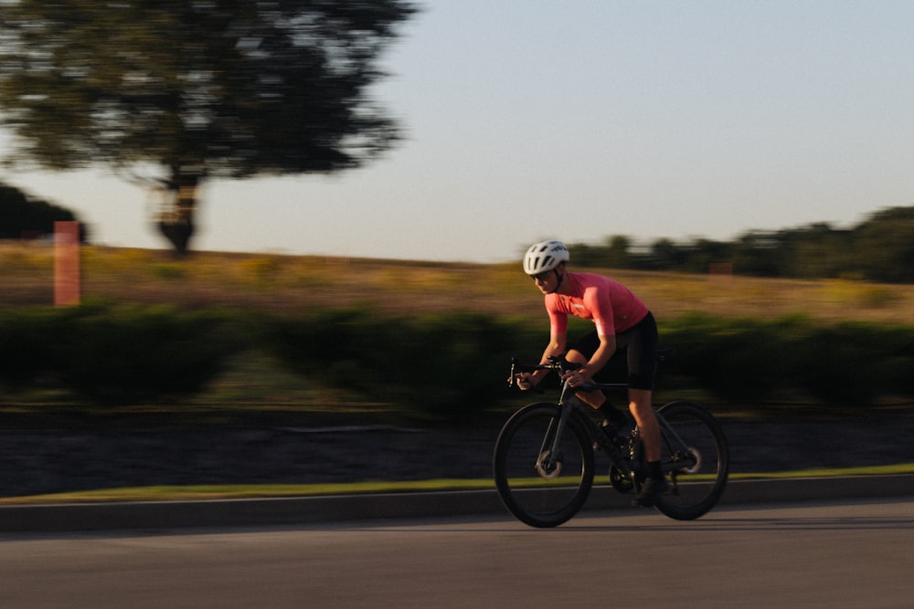 a man riding a bike down a street