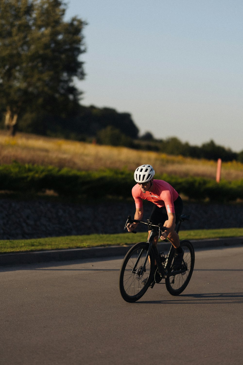 a man riding a bike down a curvy road