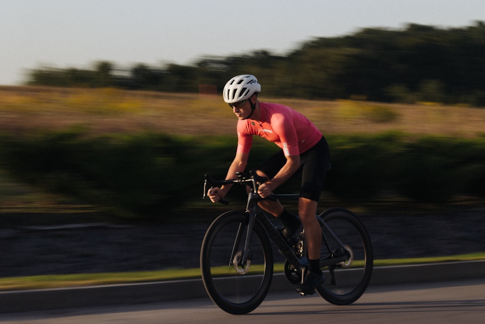 a man riding a bike down a curvy road