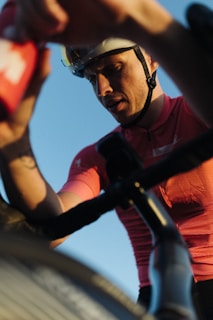 Close-up of Marco's determined face during a cycling race, sweat and grit evident.