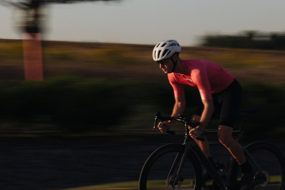 a man riding a bike down a street