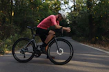 A cyclist resting on a porch of a quaint pousada surrounded by lush greenery.