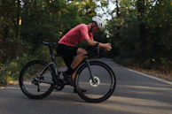 A cyclist enjoying a balanced post-ride meal with vegetables, grains, and lean protein at a cozy kitchen.