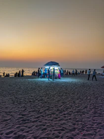 Evening view of Marina Beach with locals enjoying the sea breeze and street food vendors lighting up the shore.