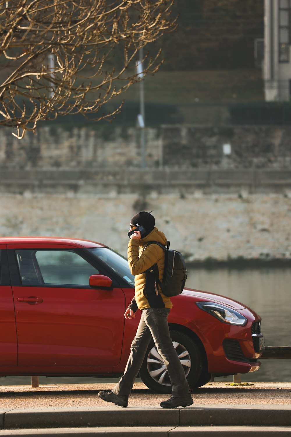 a man walking down a street while talking on a cell phone