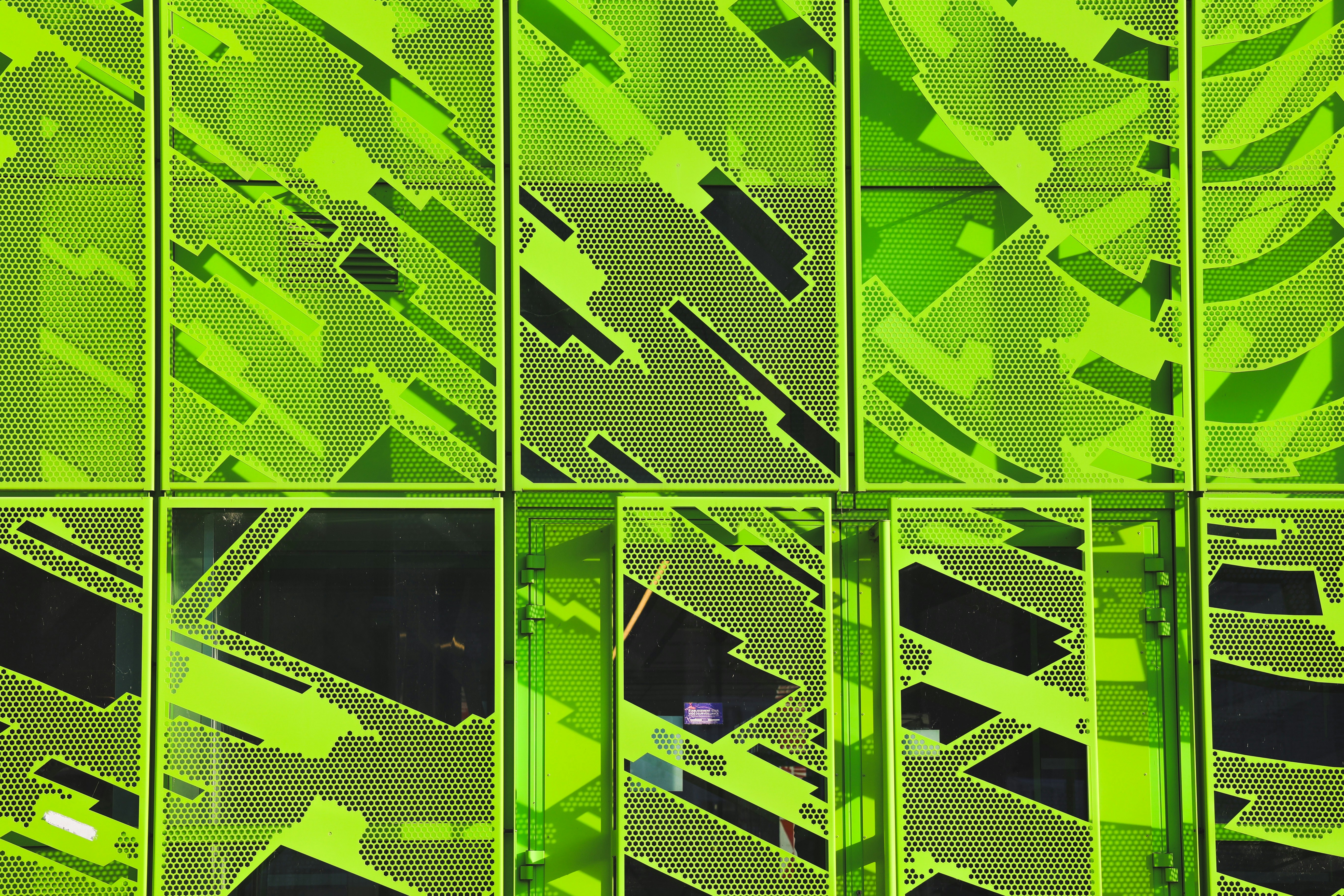 a green building with a bunch of windows