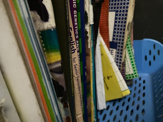 A colorful display of textbooks and notebooks tailored for IB students, arranged neatly on a classroom desk.