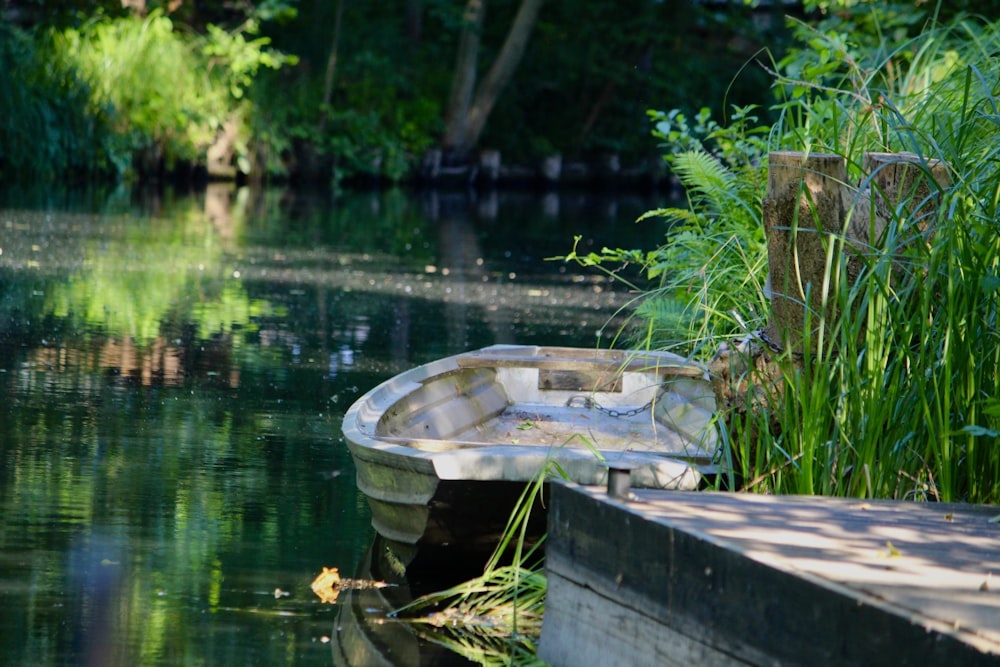 a small boat sitting on top of a body of water