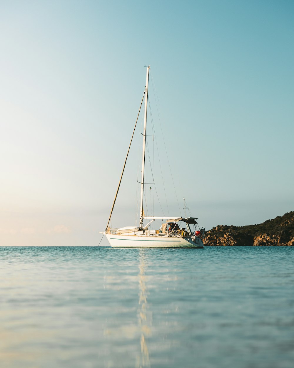 a sailboat in the middle of a body of water