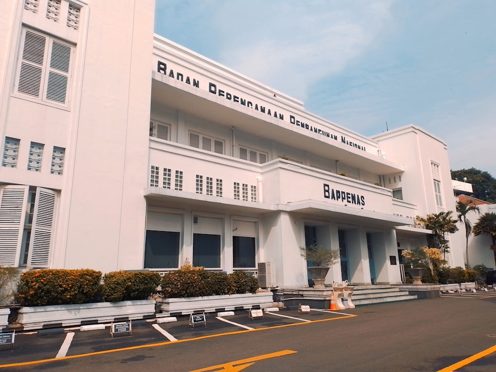 a large white building sitting on the side of a road