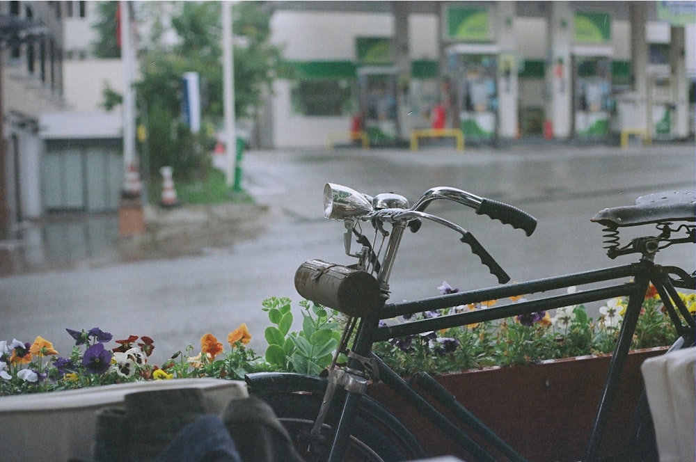 a bicycle parked in front of a flower box