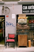 a red chair sitting in front of a building