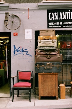 a red chair sitting in front of a building