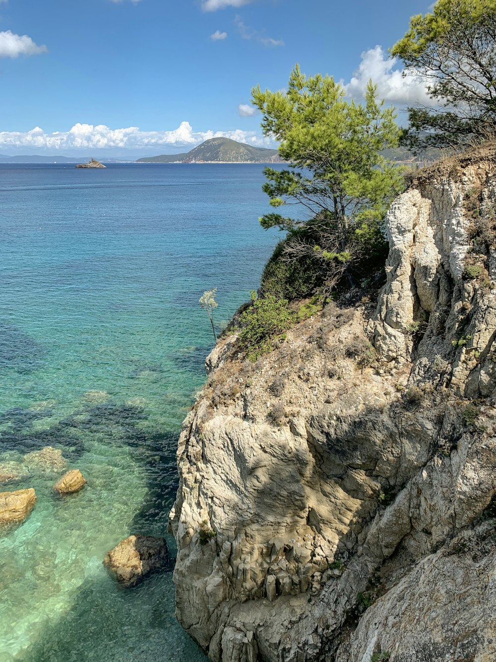 a body of water surrounded by rocks and trees