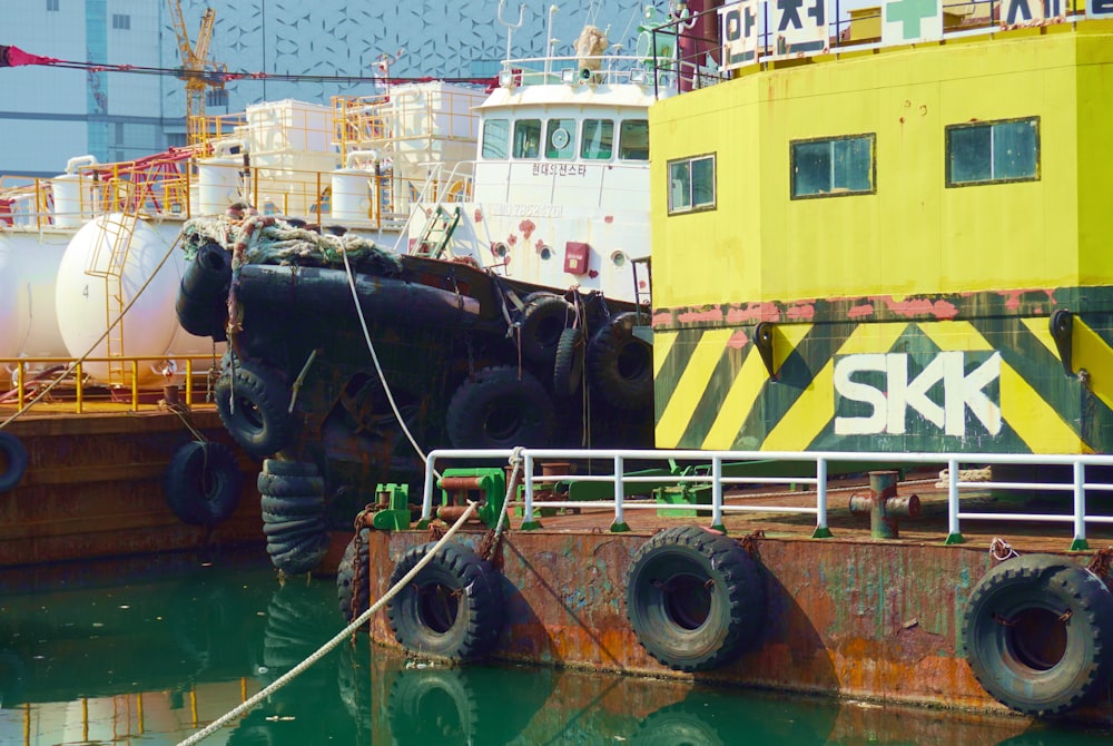 a large yellow boat sitting next to a dock