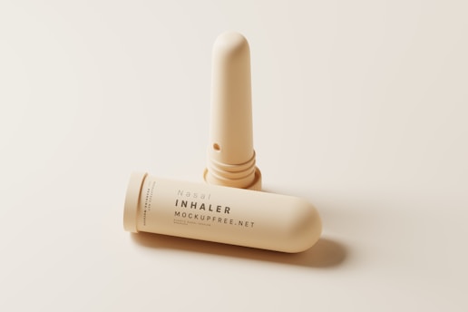 A nasal inhaler with its cap removed is displayed against a minimalist, light background. The inhaler is cylindrical and features text that reads 'Nasal Inhaler' along with a website address. The design emphasizes a clean and modern aesthetic.