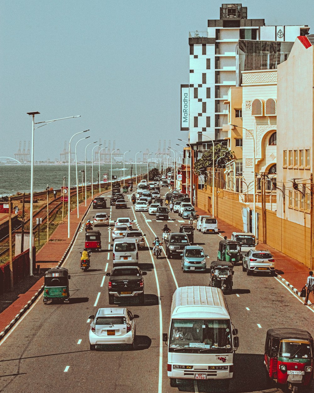 a street filled with lots of traffic next to tall buildings