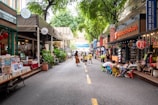 A lively street scene with people sharing stories and books under colorful banners.