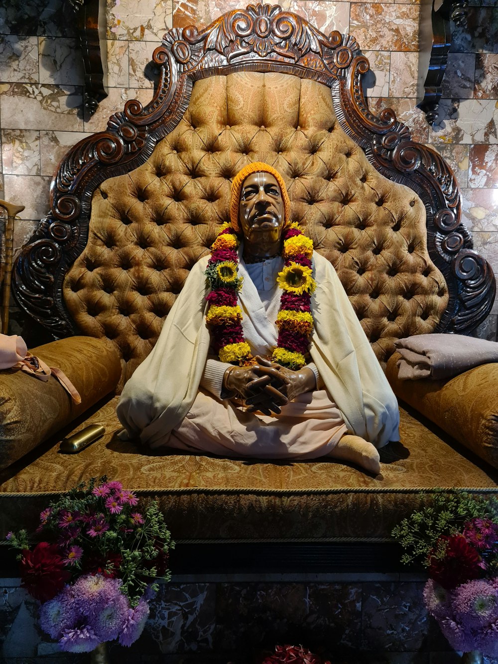 a statue of a man sitting on top of a couch