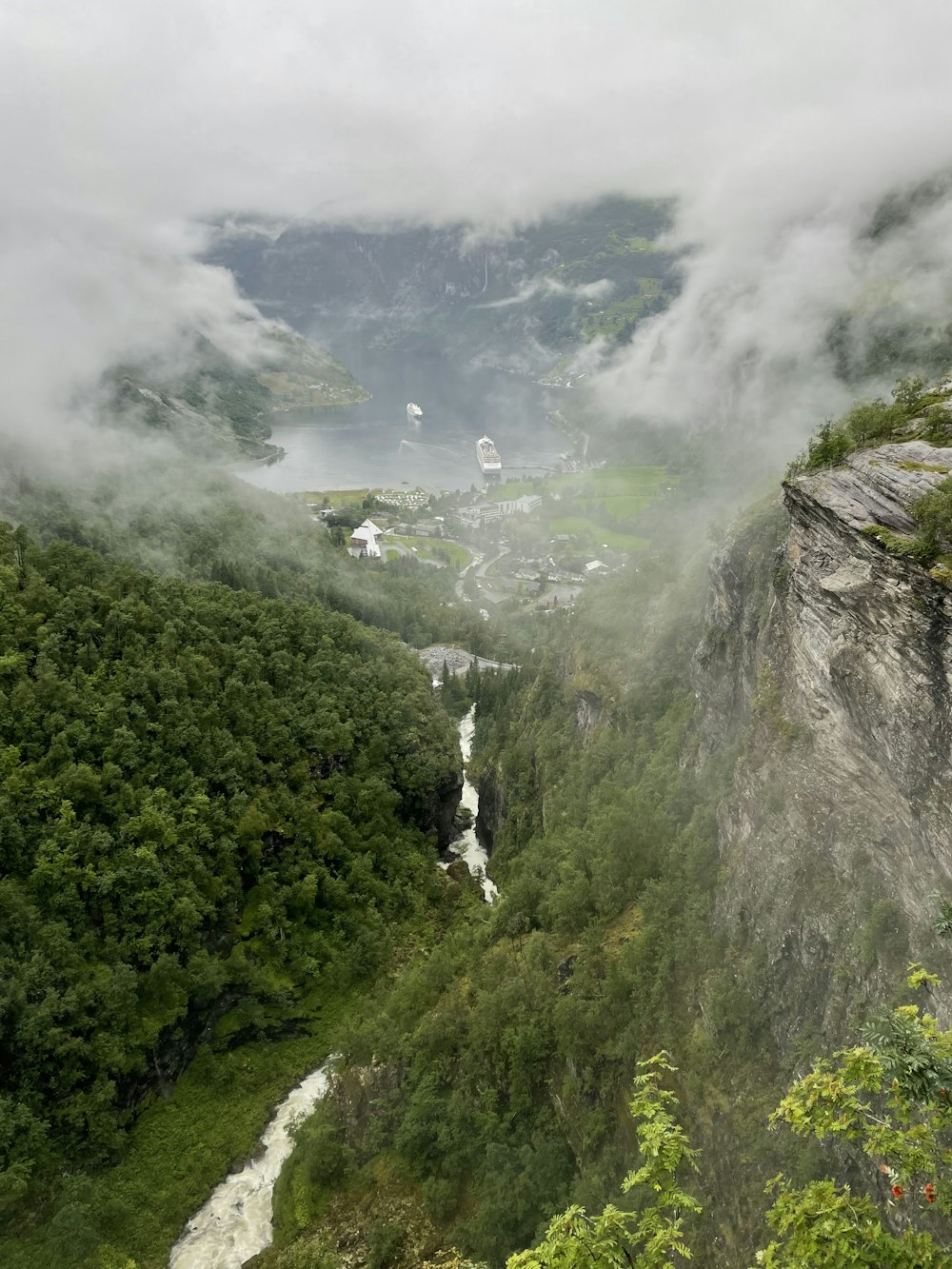 a view of a valley with a waterfall in the middle of it