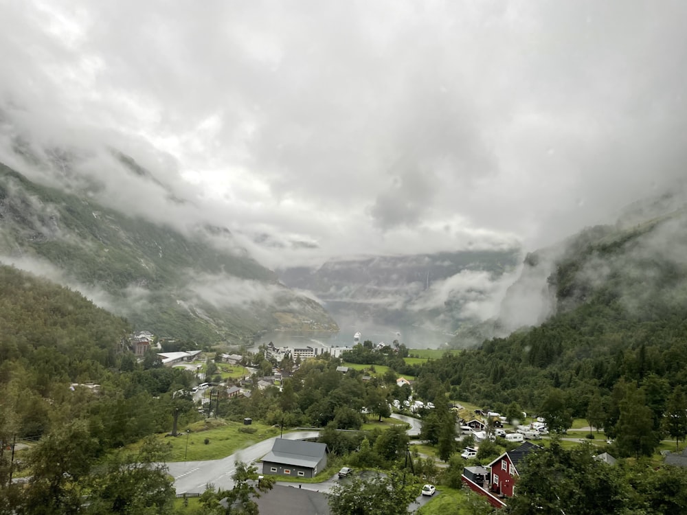 a scenic view of a town surrounded by mountains