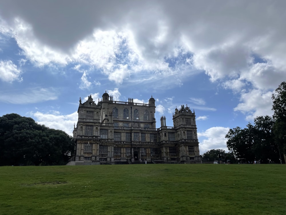 a large building sitting on top of a lush green field