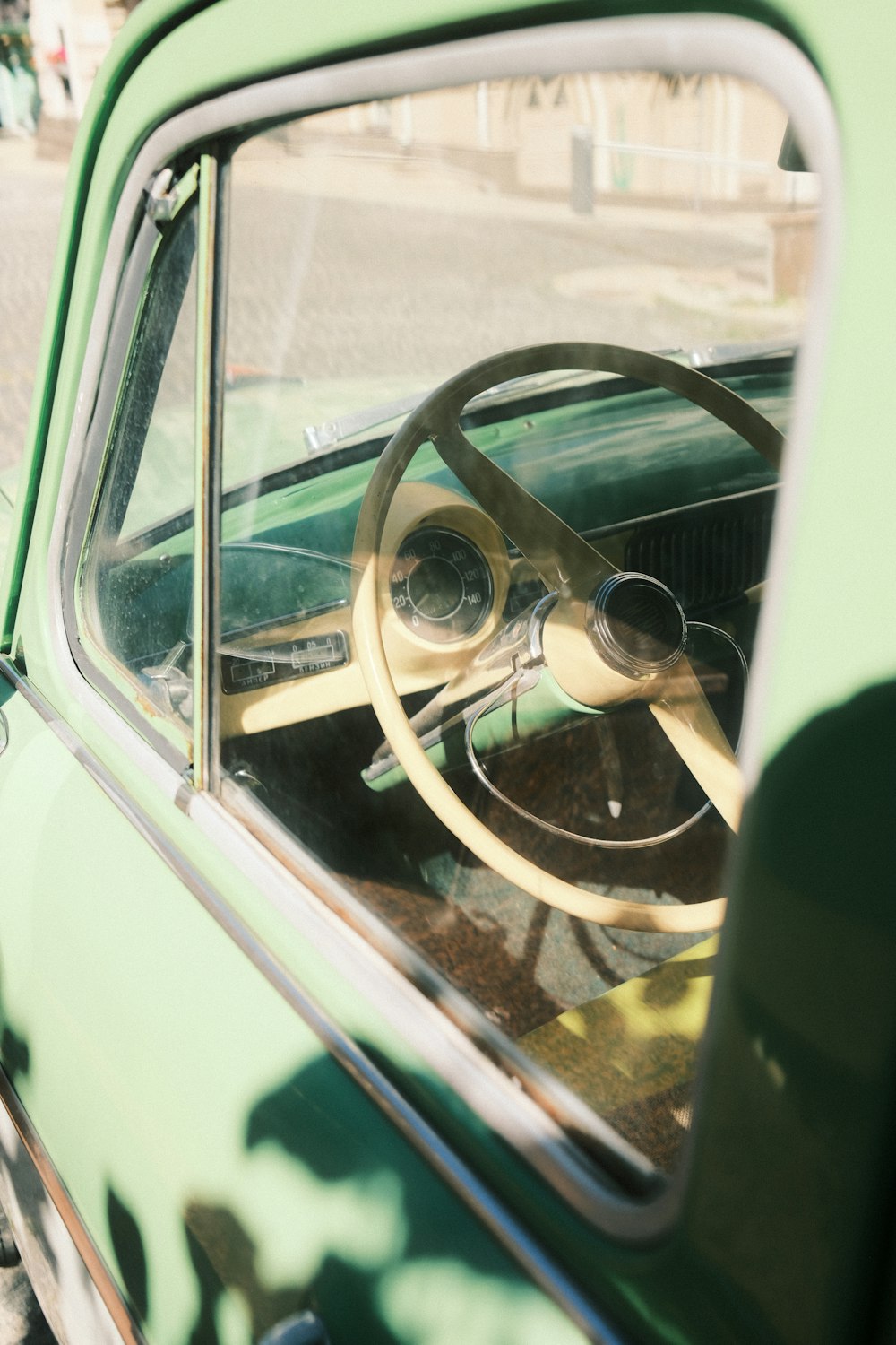 a green car with a steering wheel and dashboard