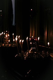 A serene living room with softly glowing candles on a table.