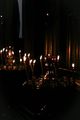 Candles lit in a quiet room, creating a peaceful atmosphere for reflection and meditation.