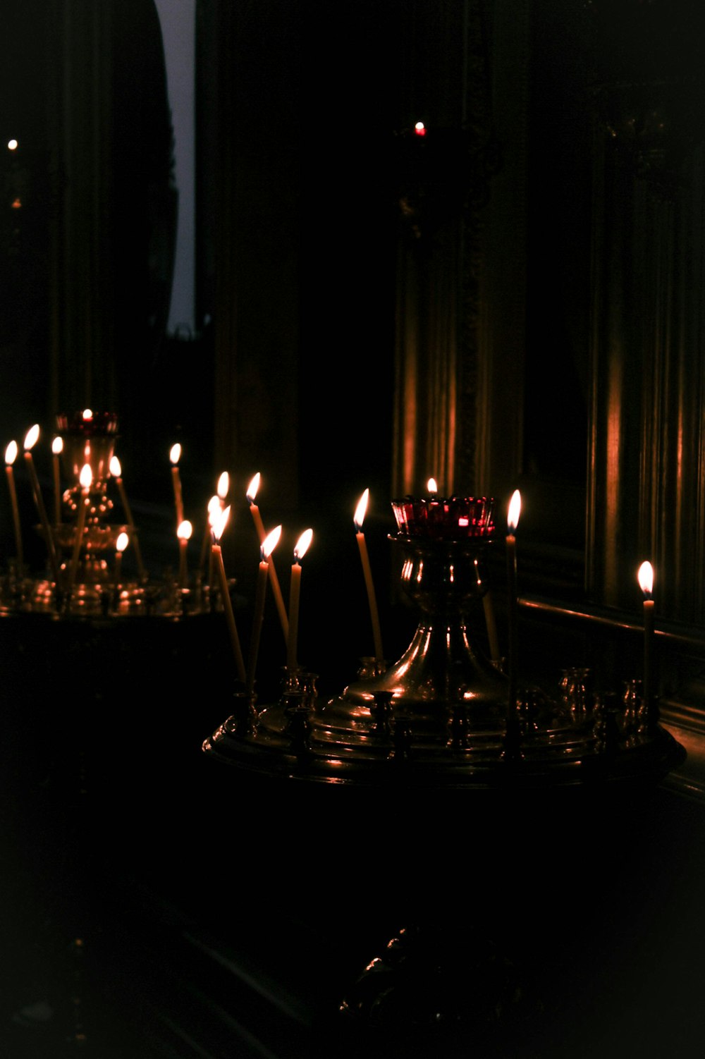 a group of lit candles sitting on top of a table