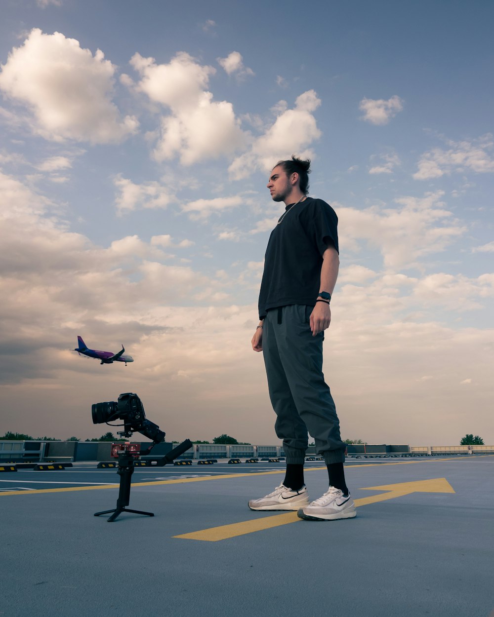 a man standing on top of a parking lot next to a fire hydrant