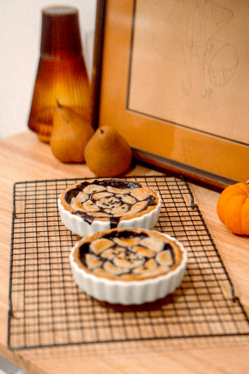 a couple of pies sitting on top of a cooling rack