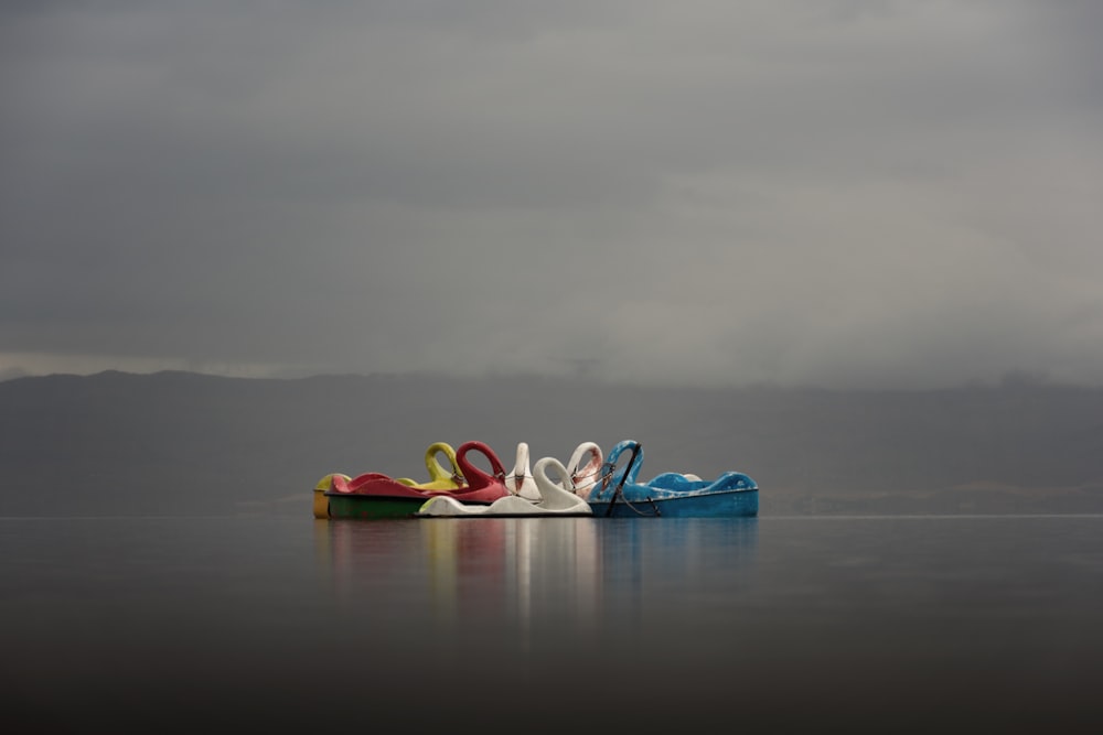 a row of colorful shoes sitting on top of a lake